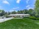 Well-maintained single-story home with a covered parking, lush lawn, and mature trees at 760 Oakdale Rd, Canton, GA 30114