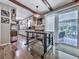 Bright kitchen and dining area with exposed beams, stainless appliances, and access to an outdoor deck at 760 Oakdale Rd, Canton, GA 30114