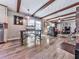 Open-concept living area with exposed beams, hardwood floors, and a brick fireplace at 760 Oakdale Rd, Canton, GA 30114