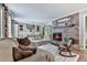 Cozy living room showcasing a brick fireplace, comfortable seating, and a dining area at 760 Oakdale Rd, Canton, GA 30114