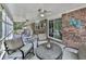 Inviting screened porch with comfortable seating and an overhead fan for outdoor enjoyment at 760 Oakdale Rd, Canton, GA 30114