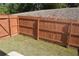 Enclosed backyard features a wood fence and green grass at 7624 Squire Ct, Fairburn, GA 30213
