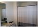 Bathroom with a gray and white striped shower curtain at 7624 Squire Ct, Fairburn, GA 30213