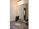 Bathroom vanity featuring a granite countertop and a decorative mirror at 7624 Squire Ct, Fairburn, GA 30213