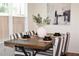 Dining area with striped chairs, a wood table, and natural light from a nearby window at 7624 Squire Ct, Fairburn, GA 30213