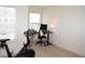 Bright flex room with a Peloton bike and home office setup at 7624 Squire Ct, Fairburn, GA 30213