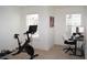 Bright flex room with a Peloton bike and home office setup at 7624 Squire Ct, Fairburn, GA 30213