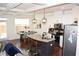 Open-concept kitchen with granite island, stainless appliances, and modern pendant lighting at 7624 Squire Ct, Fairburn, GA 30213