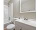 Bright bathroom with a white vanity and combination bathtub and shower at 8227 Englewood Trl, Riverdale, GA 30274