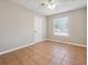 Neutral bedroom featuring a ceiling fan, a window and tile flooring at 8227 Englewood Trl, Riverdale, GA 30274