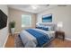 This staged bedroom has earth-tone paint, tile flooring and a view to the outside at 8227 Englewood Trl, Riverdale, GA 30274