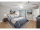 This staged bedroom has earth-tone paint, tile flooring and a view to the outside at 8227 Englewood Trl, Riverdale, GA 30274