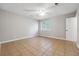 Bedroom features a ceiling fan, a window and tile flooring at 8227 Englewood Trl, Riverdale, GA 30274