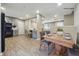 Open-concept dining room with wood floors, connecting the kitchen and living areas at 8227 Englewood Trl, Riverdale, GA 30274