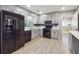 Classic kitchen with black appliances, stylish backsplash, and abundant cabinet storage at 8227 Englewood Trl, Riverdale, GA 30274
