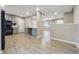 Open-concept kitchen featuring black appliances and light gray walls, connecting to the dining area at 8227 Englewood Trl, Riverdale, GA 30274