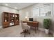 Bright home office with a modern desk, a bookshelf, and natural light from the window at 8227 Englewood Trl, Riverdale, GA 30274