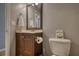 Bathroom featuring a wooden vanity, toilet with decor and painted walls at 95 Loudoun Dr, Covington, GA 30014