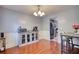 An open dining area with modern table, lighting, and decorative wall accents, adjacent to the kitchen at 95 Loudoun Dr, Covington, GA 30014