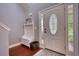 Inviting entryway featuring a hall tree with storage, a decorative door, and hardwood floors for a warm welcome at 95 Loudoun Dr, Covington, GA 30014