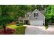 Charming home exterior with two car garage, complimented by a lush lawn and mature trees at 95 Loudoun Dr, Covington, GA 30014