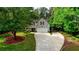 Charming home featuring a well-manicured front yard and a long driveway, nestled among mature trees at 95 Loudoun Dr, Covington, GA 30014