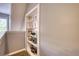 Hallway with carpeted floors, painted walls and built in shelving at 95 Loudoun Dr, Covington, GA 30014