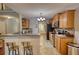 Bright kitchen featuring wooden cabinets, stainless steel appliances, tile floors, and breakfast bar seating at 95 Loudoun Dr, Covington, GA 30014