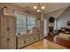 Well-lit kitchenette featuring decorative cabinets, window with blinds, and tile flooring at 95 Loudoun Dr, Covington, GA 30014
