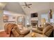 Spacious living room with fireplace, ceiling fan, hardwood floors, and neutral paint colors at 95 Loudoun Dr, Covington, GA 30014