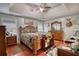 Spacious main bedroom featuring hardwood floors, a ceiling fan, and decorative furniture at 95 Loudoun Dr, Covington, GA 30014