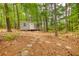 View of an outbuilding with stone walkway in the woods on the property at 95 Loudoun Dr, Covington, GA 30014