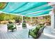 Relax on this expansive outdoor patio with green furniture, picnic tables, and a shade covering at 95 Loudoun Dr, Covington, GA 30014