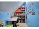 Play room with colorful walls, built in shelving, table and other toy storage at 95 Loudoun Dr, Covington, GA 30014