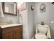 Cozy powder room featuring a wooden vanity, framed mirror, and decorative wall sconces at 95 Loudoun Dr, Covington, GA 30014