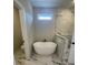 Modern bathroom featuring a freestanding tub, walk-in shower, and elegant tile at 129 Silvercrest Dr, Acworth, GA 30101