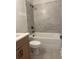Modern bathroom with a tiled shower and tub, stylish fixtures, and a wooden vanity at 129 Silvercrest Dr, Acworth, GA 30101