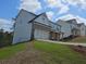 Exterior side view of a lovely two-story home with a front facing two-car garage at 129 Silvercrest Dr, Acworth, GA 30101