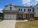 Beautiful two-story home with gray brick, a front-facing garage, and a well-manicured lawn at 129 Silvercrest Dr, Acworth, GA 30101