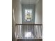 Hallway with a chandelier and black iron railing overlooking a lower level at 129 Silvercrest Dr, Acworth, GA 30101