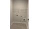 A cozy laundry room with neutral paint, tile flooring, and wire shelving at 129 Silvercrest Dr, Acworth, GA 30101