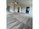 Large open-concept living room with neutral carpet, crown molding, and ample natural light at 129 Silvercrest Dr, Acworth, GA 30101