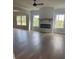 Spacious living room featuring a modern fireplace, dark hardwood floors, and bright natural lighting at 129 Silvercrest Dr, Acworth, GA 30101