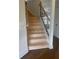 Staircase with light wood steps and black wrought iron railing at 129 Silvercrest Dr, Acworth, GA 30101