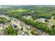 Overhead view of tree-lined neighborhood with tennis courts and community pool at 2084 Democracy Dr, Buford, GA 30519