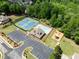 A serene view of a residential neighborhood pool, tennis courts, playground and clubhouse at 2084 Democracy Dr, Buford, GA 30519
