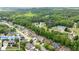 Expansive aerial view of a neighborhood with lush green trees and well-maintained homes at 2084 Democracy Dr, Buford, GA 30519