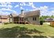 Back exterior of the home with a screened in porch and wooden deck at 2084 Democracy Dr, Buford, GA 30519