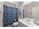 Clean bathroom featuring a vanity with a sink and a blue floral-patterned shower curtain at 2084 Democracy Dr, Buford, GA 30519