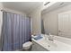 Clean bathroom with a vanity, toilet, and shower with a blue striped curtain at 2084 Democracy Dr, Buford, GA 30519